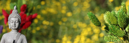 Buddha Statue With Field of Yellow Flowers in Backgroundの写真素材