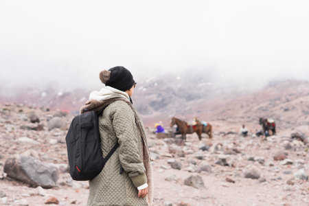 Young woman on an adventure in the mountains, enjoying the beautiful view.の写真素材