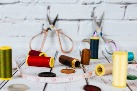 Sewing accessories on white tableの写真素材