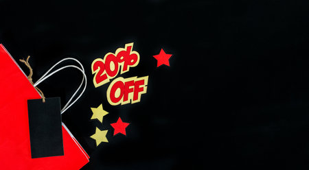 Super Sale. Black Friday. Red shopping bag on black background.