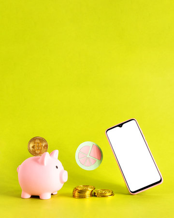 Piggy bank on smart phone and bit coins. Savings concept.の写真素材