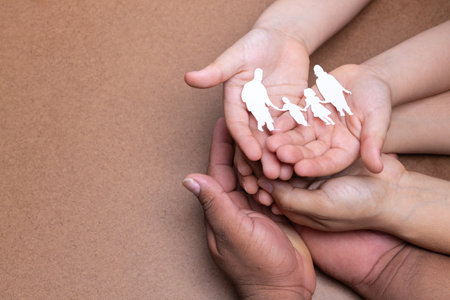 hands holding family picture, chocolate backgroundの写真素材