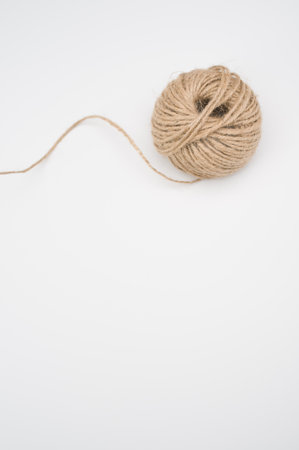 A closeup of a stationary yarn ball isolated on a white background
