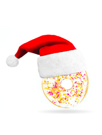 Sweet donut with christmas cap on white background. Concept December Santa Claus food.の写真素材