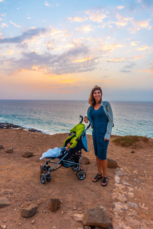 A mother with her son walking at West Coast Photo Point in the town of El Cotillo in the north of...