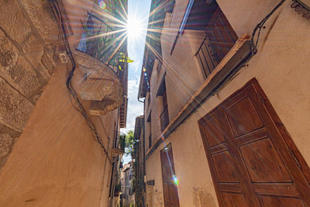 Old rustic traditional mediterranean house with narrow alley wall facade in La Fresnada Teruel Spain