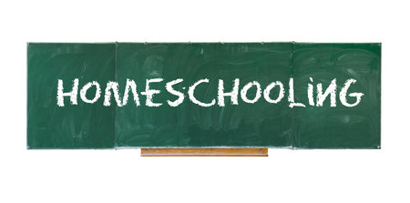 Homeschooling. Word Homeschooling writing on old green blackboard isolated on white backgroundの写真素材