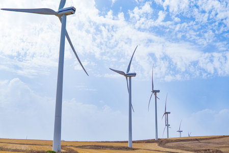 Green energy concept, eco power. Wind turbine located along the hill