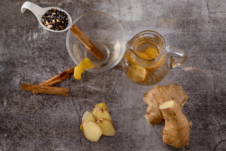 preparation of a ginger and cinnamon infusion with fresh produce natural roots and cinnamon stick...
