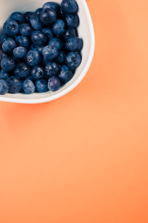 fresh and tasty organic blueberries in a white decorative ceramic bowl with copy spaceの写真素材