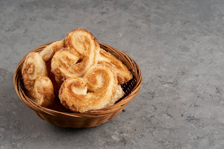 basket with puff pastry palmeritas, also known as orejitas (little ears)の写真素材