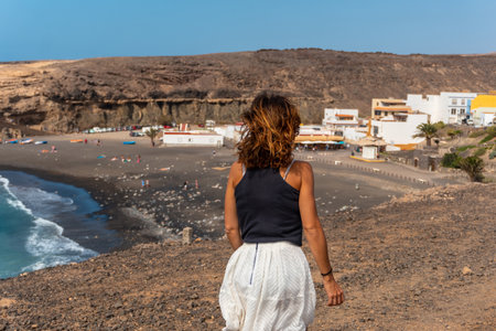 A young girl on vacation on the beach of Ajuy, Pajara, west coast of the island of Fuerteventura,...