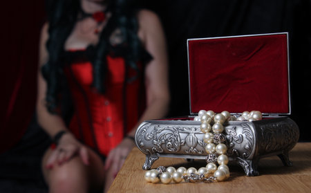 Vintage Jewelry Box with Pearls, Woman in red corset Shallow DOFの写真素材