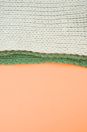 hand knitted soft wool on an orange background with copy spaceの写真素材