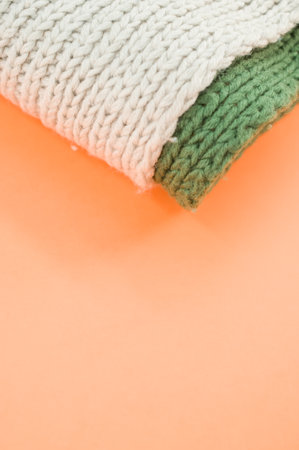hand knitted soft wool on an orange background with copy space