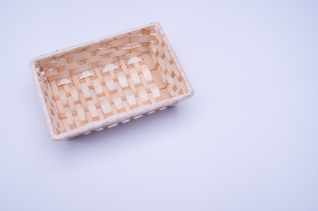 empty rectangular wicker canister on a white background with text spaceの写真素材