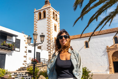 A young tourist enjoying the holidays next to the white church of Betancuria, west coast of the island of Fuerteventura, Canary Islands. Spainの写真素材