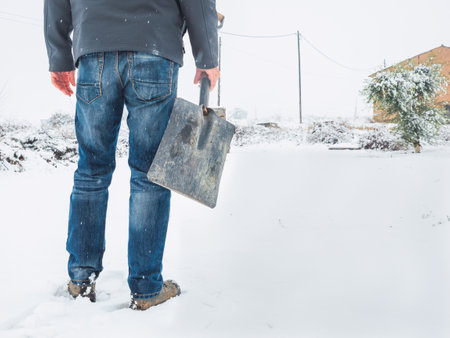 Man with shovel to remove snow from the trail after a snowstorm. Winter conceptの写真素材