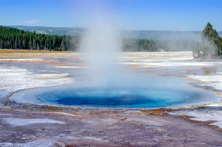 deep blue thermal pool in Yellowstone national park looks like a beautiful place to relax in, but the boiling heat and acidic water would be a dangerの写真素材
