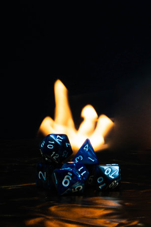 Blue dices tower with fire in the backgroundの写真素材