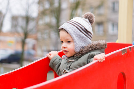 Child walking on a climbing equipment of a play groundの写真素材
