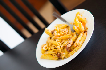 Pasta with salmon and dry tomatoesの写真素材