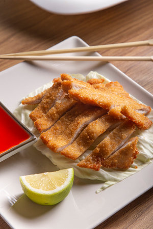Oriental style battered chicken fillet with sweet and sour sauce, vertical image.の写真素材