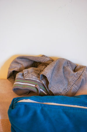Weared child pants on a sofa
