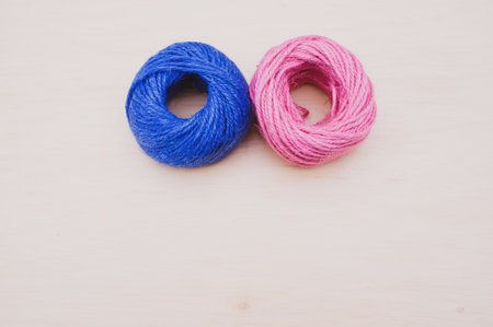 multicolor decoration yarns on a bright wooden background with copy spaceの写真素材