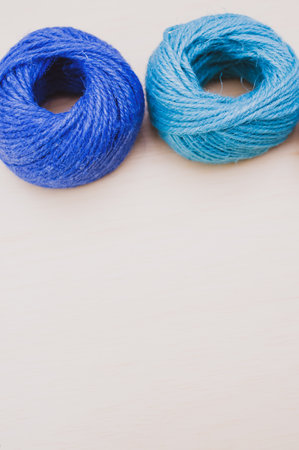 multicolor decoration yarns on a bright wooden background with copy spaceの写真素材