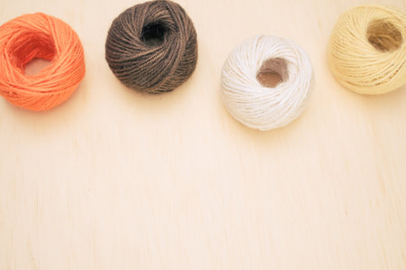 multicolor decoration yarns on a bright wooden background with copy spaceの写真素材