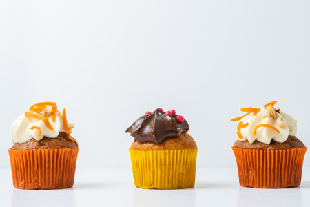 assortment of chocolate and cream and carrot cupcakes on various backgroundsの写真素材