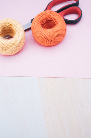multicolor decoration yarns with scissors on a bright wooden background with copy spaceの写真素材