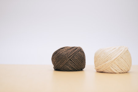 multicolor decoration yarns on a bright wooden background with copy spaceの写真素材