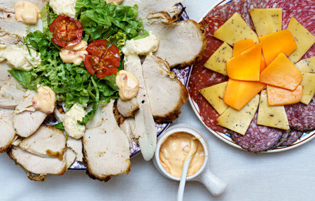 table cold cuts cheeses sliced chicken breast garnishes Top viewの写真素材