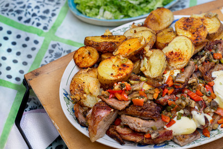 Oven roasted meat and potatoes with vegetablesの写真素材