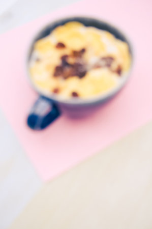 Fresh tasty breakfast with milk raisin and cereal with copy space on wooden tabletopの写真素材
