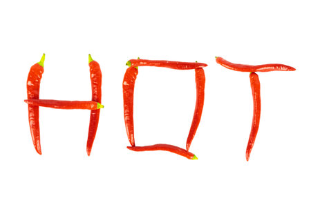 The word hot from red chili peppers on white backgroundの写真素材