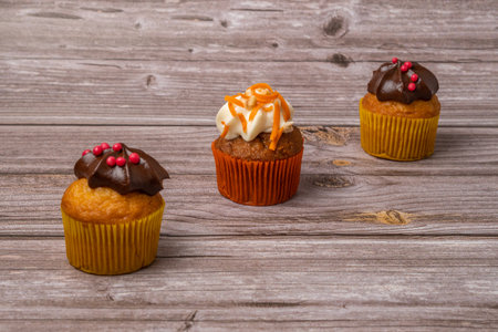 assortment of chocolate and cream and carrot cupcakes on various backgroundsの写真素材
