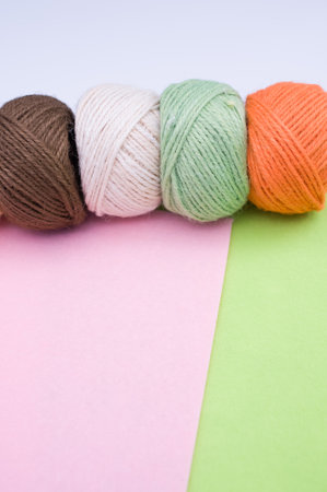 multicolor decoration yarns on a bright colored background with copy space
