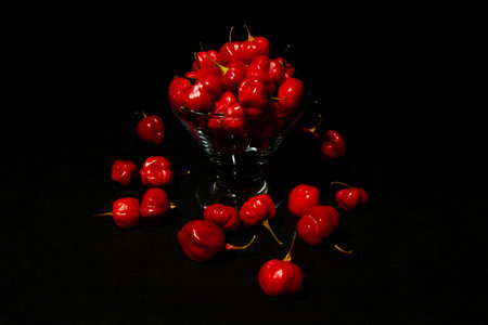 Red chilli peppers on black background