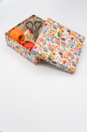 paperboard flower decorated box on white background with text space and stationery