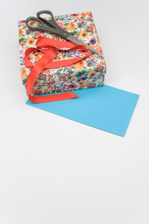 a closed cardboard decorated box with stationery and letter paper on white background with text spaceの写真素材
