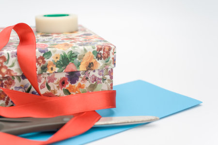 decorated box with stationery and letter paper on white background with text space