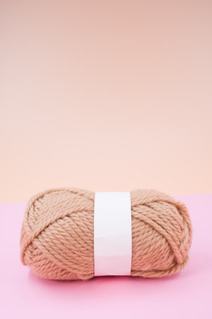 isolated beige yarn on pink background with text spaceの写真素材