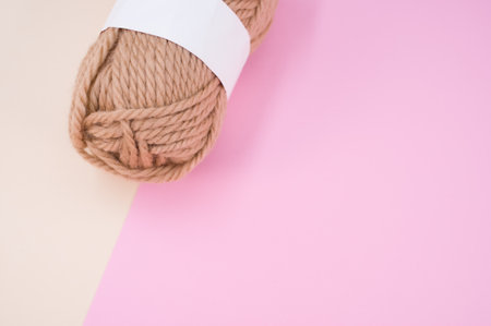 isolated beige yarn on pink background with text spaceの写真素材