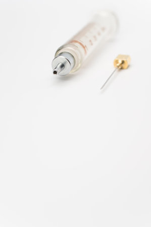 an isolated injection syringe on white paper background with text spaceの写真素材
