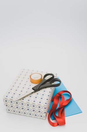 a closed white paperboard decorated box on white background with text spaceの写真素材