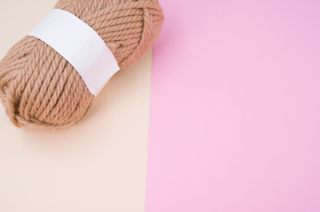 isolated beige yarn on pink background with text spaceの写真素材