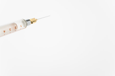 an isolated injection syringe on white paper background with text spaceの写真素材